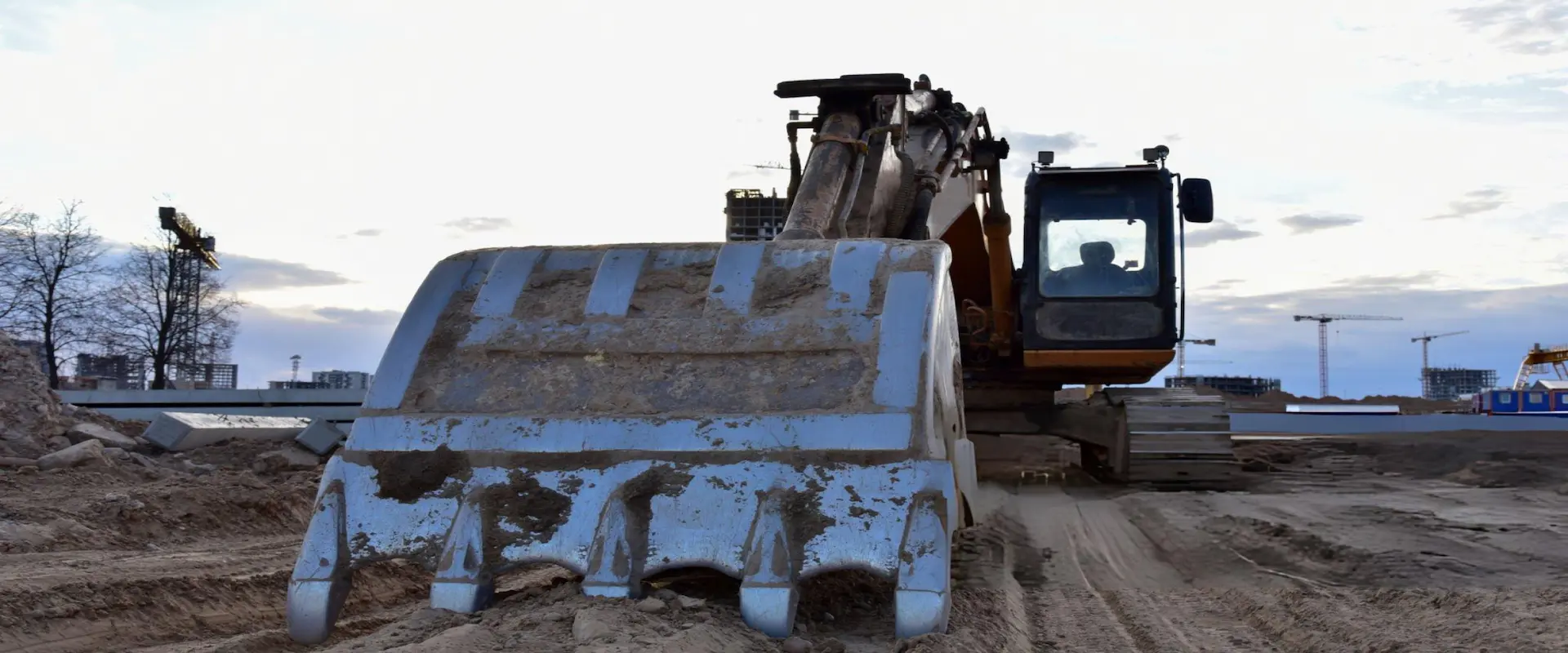 Close-up of a high-capacity excavator on a construction site representing INTEREQ heavy machinery export services.