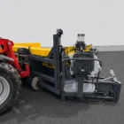 Road widening paver side view mounted to a tractor with operator seat