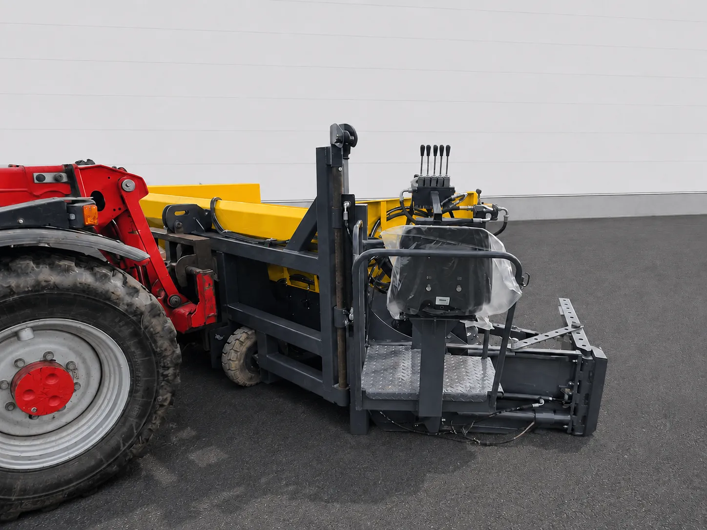 Road widening paver side view mounted to a tractor with operator seat