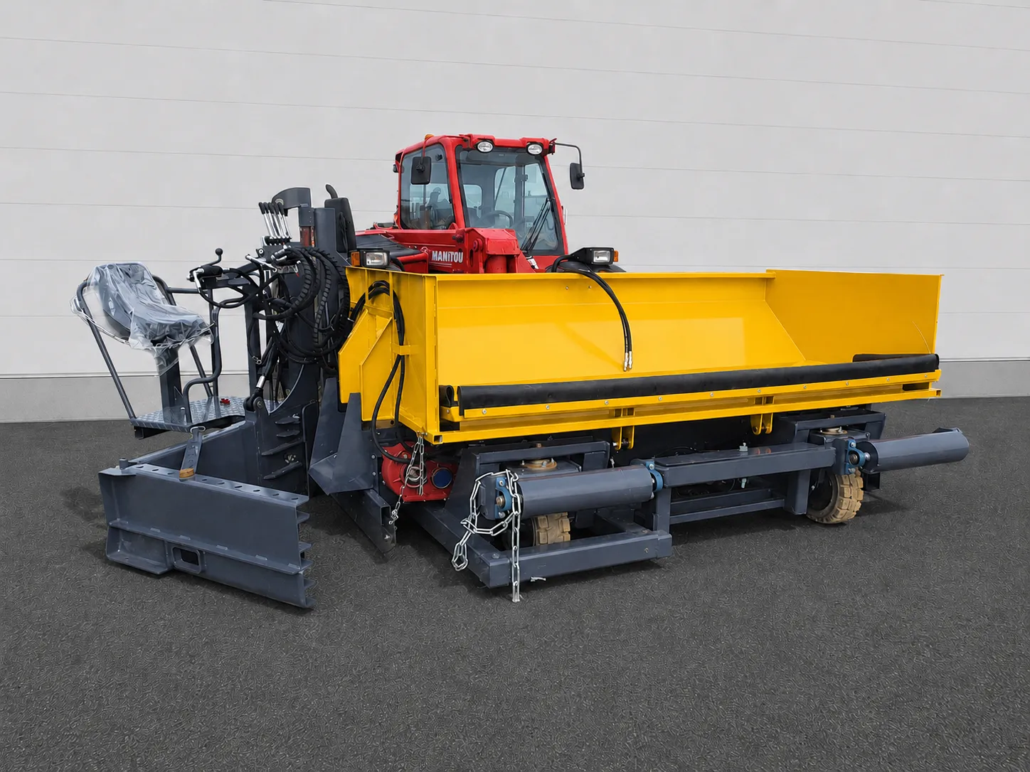 Road widening paver mounted to a red Manitou tractor with operator seat and hydraulic hoses