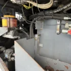 Voegele Super 1800-1 asphalt paver engine compartment with hydraulic reservoir and lines