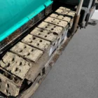 Voegele Super 1800-1 asphalt paver close-up of the crawler track pads