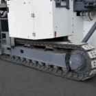 Voegele MT 1000-1 asphalt feeder close-up of a crawler track with rubber pads and access ladder