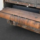 Voegele MT 1000-1 asphalt feeder close-up of the receiving hopper roller and metal apron