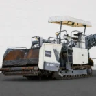 Voegele MT 1000-1 asphalt feeder three-quarter view with receiving hopper, operator canopy and raised conveyor