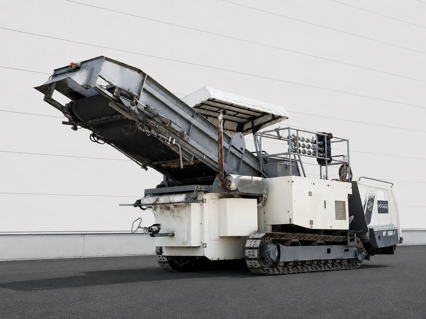 Voegele MT 1000-1 asphalt feeder rear three-quarter view with raised conveyor