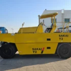 Sakai T2 asphalt roller side view with operator canopy and road drums