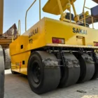 Sakai T2 asphalt roller rear three-quarter view showing the yellow body and steel drums