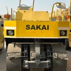 Sakai T2 asphalt roller rear view with lights, drums and operator canopy